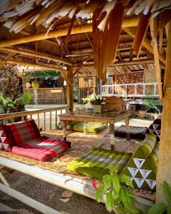 a patio with a bench and a table at Leaf House Bungalows in Ko Lanta