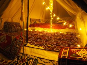 a bedroom with a bed with lights on it at Butterfly Valley Beach Glamping with Food in Oludeniz