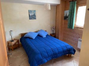 a bedroom with a blue bed in a room at M3 in Le Grand-Bornand
