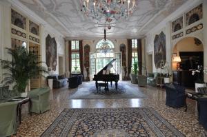 a room with a grand piano in a building at Hotel Villa Condulmer in Mogliano Veneto