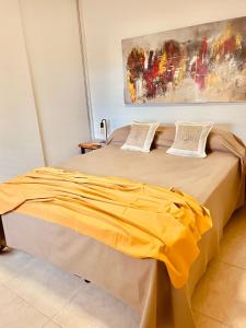 a bedroom with two beds with yellow sheets at COMPLEJO ZAPALA in Villa Hipódromo