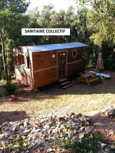 Cabaña pequeña con tienda y mesa de picnic en Camping Ibie, en Lagorce