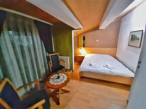 a bedroom with a bed and a table and a chair at ***Vila To&scaron;e D. Kru&scaron;evo in Kru&scaron;evo