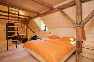 a bedroom with a bed in a room with wooden walls at NATUR BAJTA in Solčava