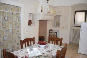 a kitchen with a table with a bowl of fruit on it at Dimora Domrose in Locorotondo +123 photos