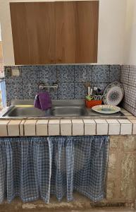 a kitchen counter with a sink at Dimora Mimmi Marina di Mancaversa - Gallipoli in Marina di Mancaversa