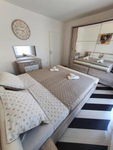 a bedroom with a large bed and a mirror at Lavanda Samarin in Zambratija +18 photos