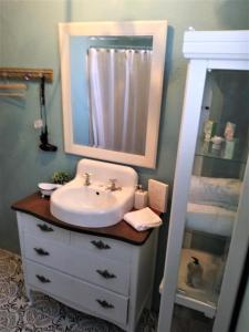 a bathroom with a sink and a mirror at COZY NEST in Guayama