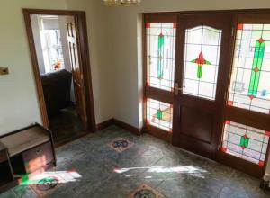 a room with stained glass windows in a house at Corraglass House - close proximity to Cuilcagh in Letterbreen