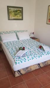 a bed in a room with flowers on it at Apartments Katarina in Sutivan