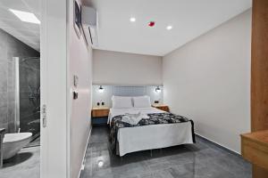 a bedroom with a bed and a tub and a sink at KADAGAN SUİTES AYASARANDA in Çeşme