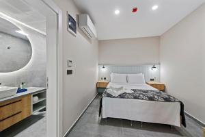 a bedroom with a bed and a sink at KADAGAN SUİTES AYASARANDA in Çeşme