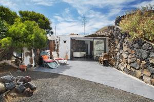 een stenen huis met een patio en een stenen muur bij La Bodeguita House in Haría