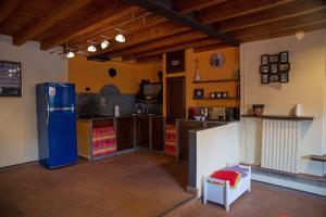 a kitchen with a blue refrigerator in a room at Casa Dolce Casa Alzaia Grande in Milan