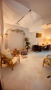 a large living room with a table and chairs at Angel Spa Garden's Homestay in Ipoh