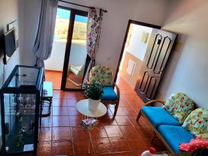 a living room with a couch and chairs and a table at casa mariposa in Playa de Santiago