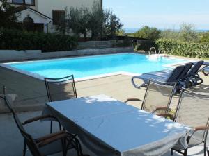 a table and chairs next to a swimming pool at Lavanda Samarin in Zambratija
