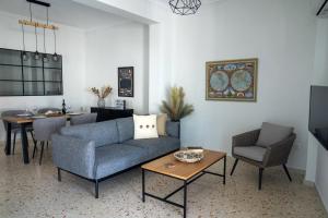 a living room with a couch and chairs and a table at Athens Glance Apartments in Athens