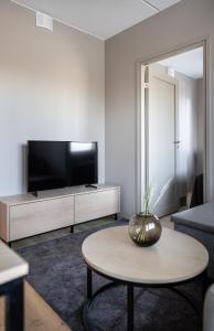 a living room with a tv and a coffee table at Levin Kunkku B4 in Levi +2 photos