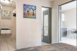 a room with a door and a painting on the wall at Latitude Adjustment in San Juan
