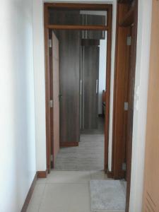 a hallway with two doors and a room with a floor at Shanzu Beach apartment with stunning Ocean view in Mwakirunge