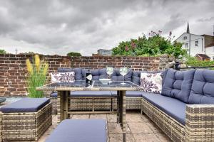 a blue couch on a patio with a table at 10 Westgate Street Southampton in Southampton