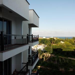 an apartment building with balconies and the ocean in the background at Shanzu Beach apartment with stunning Ocean view in Mwakirunge