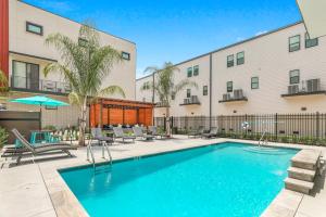 a swimming pool in front of a building at Private Living Villa Near City Hot Spots in New Orleans
