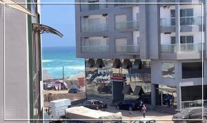 a view of a building with the ocean in the background at Nalabba in Dakar