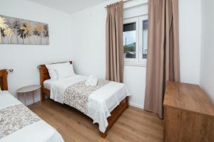 a hotel room with two beds and a window at Family house Moja jube in Oklaj +36 photos