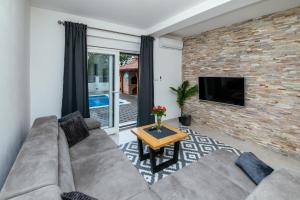 a living room with a couch and a table at Family house Moja jube in Oklaj