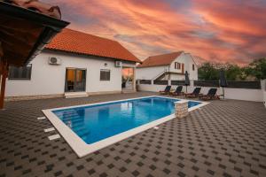a swimming pool in the backyard of a house at Family house Moja jube in Oklaj