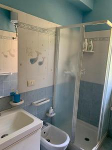 a bathroom with a shower and a sink and a toilet at Sea House in San Giorgio