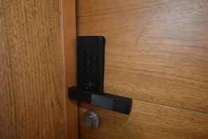 a black door knocker on a wooden door at Atmospheric apartment with a beautiful view of the swimming pool in Bayahibe