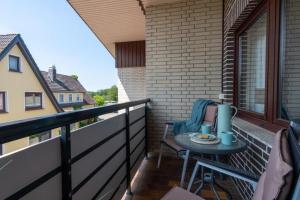 a small table on the balcony of a house at Haus-Schwanensee-Wohnung-27-Kajaknutzung-inklusive in Bosau