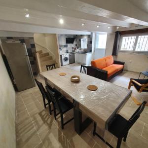 a kitchen and living room with a table and chairs at Maison Agnes et Johann in Sauvian