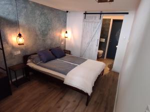 A bed or beds in a room at Napraszállás Vendégház