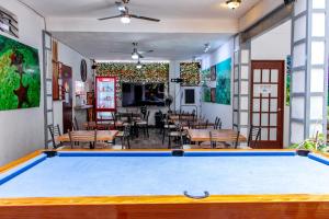 a pool table in a room with tables and chairs at Acapulco Amor in Acapulco