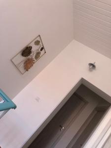 a room with a white wall with two pictures on the wall at Home Ciccilla in Reggio Calabria +25 photos