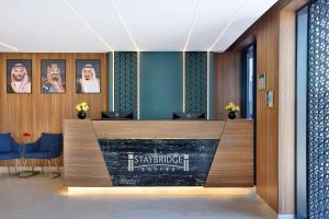 a lobby with a reception desk in a building at Staybridge Suites - Al Khobar City, an IHG Hotel in Al Khobar