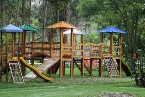 a wooden playground with a slide and play equipment at Posada del Puruay in Cajamarca +78 photos