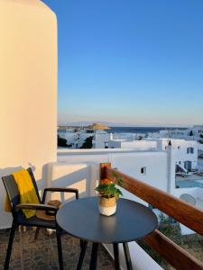 a table and chairs on a balcony with a view at Esperides in Platis Gialos
