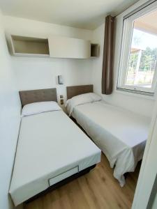 A bed or beds in a room at Garda Di Vino Agricamping & Wine Shop Lazise