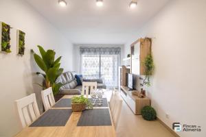 a living room with a table and a couch at Apartamento Residencial Mirador Playa Serena in Roquetas de Mar