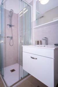 a bathroom with a shower and a sink at The Blueview Appartements Novigrad in Novigrad Istria