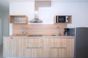 a kitchen with a sink and a refrigerator at The Blueview Appartements Novigrad in Novigrad Istria