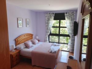 a bedroom with a bed and a large window at VistaMar beautiful apartment with amazing sea view Pineda de Mar in Pineda de Mar
