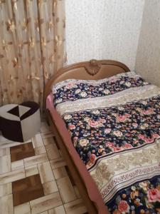 a bed with a quilt on it in a room at Portak GuestHouse Near SEVAN Lake in Sevan