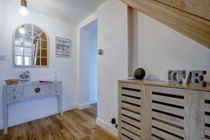 a room with a dresser and a window at Norfolk Luxe Beach House Sleeps 8 Dog friendly in Heacham +25 photos