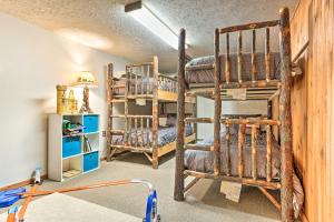 a room with two bunk beds and a lamp at Walk to Lake and Beach Pocono Cabin with Fire Pit in Pocono Lake